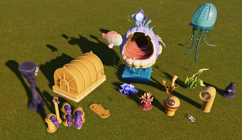 Diverse Water-Decorobjecten, waaronder een paarse Rif-zuil (met zeepokken erop), gele Duikbootonderdelen, een Zeemonster-animatronic, een Visballon, een blauwe Kwalballon en diverse kleinere Koraal-replica's.