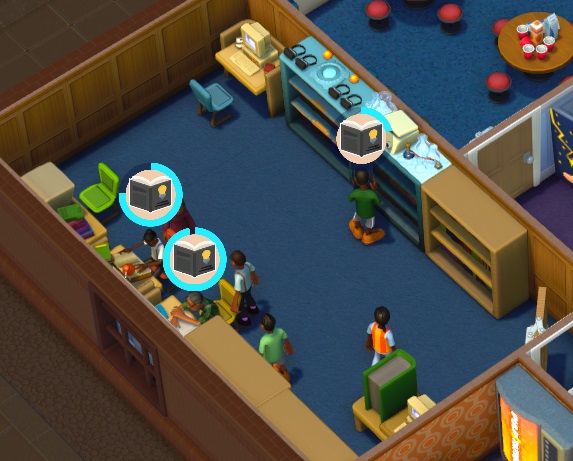 Vogelperspectief van een Bibliotheek met onderaan het bureau waar de Assistent zijn/haar administratie doet. In de Bib staan de vier 'cubicles' (Computer, Study, Textbook en Records), net als een Virtual Normality Bookcase en een Scientography Bookcase. Studenten zitten aan de cubicles of staan aan een Boekenrek, druk bezig met hun Huiswerk. De Assistent(e) wandelt weg van zijn/haar bureau - neemt hij/zij pauze?