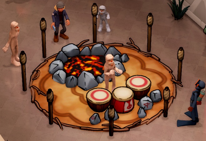 De Drum Circle II heeft extra stenen in de cirkel, en een uitgedoofd 'kampvuur' tegenover de trommels. Een Yeti slaat op de trommels; diverse Bezoekers staan rond de Drum Circle.