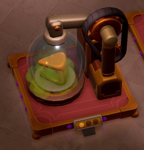 Een Gas Device omvat een glazen stolp met een kaaspunt eronder. De kaas geeft een groen gas af, dat via een metalen stang in de eigenlijke machine geleid wordt. De machine heeft twee tandwielen met een drijfriem errond.