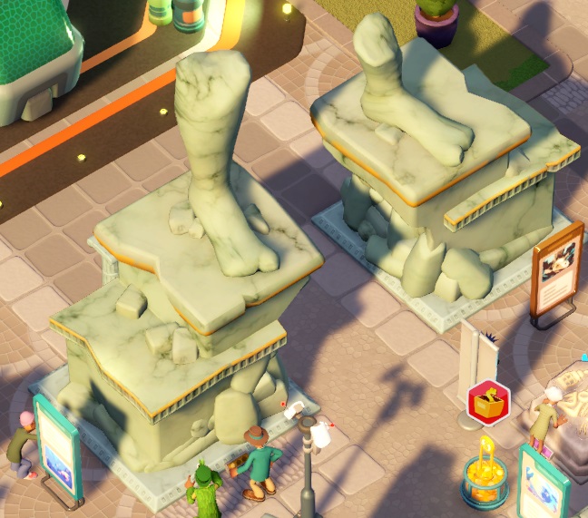 De Statue Ruins bestaan uit twee stenen voetstukken, met de restanten van een gebeeldhouwde linker- en rechtervoet. Bezoekers bekijken de ruïnes terwijl een Marine Life Expert op het punt staat, Onderhoudswerkzaamheden uit te voeren.